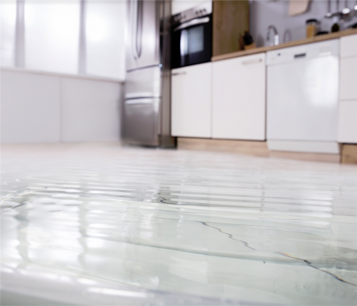 water covering the tile floor of a kitchen