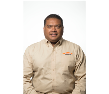 male posing in tan servpro uniform